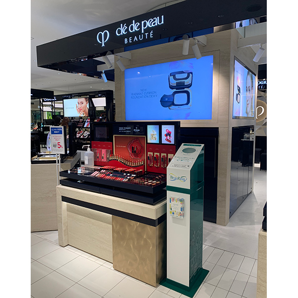 BeauRing collection box for used packaging next to a Clé de Peau Beauté product display