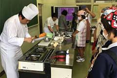 Students watching the skillful techniques of the grand chef  