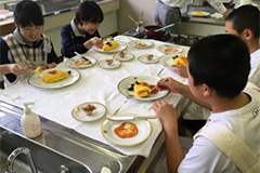 Students enjoying the omelet with rice they made